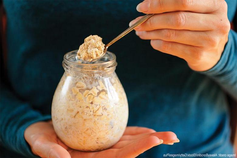 image of hands holding overnight oatmeal in a glass jar